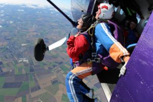 Two women about to parachute out of a plane
