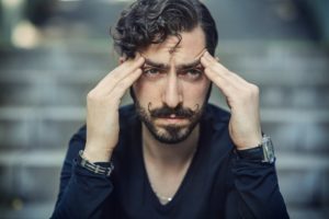 Man holding his temples in stress
