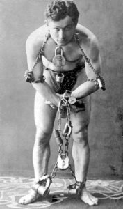 Harry Houdini locked up in chains