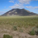 A mountain in the background on the trail of the Atomic City to Big Southern Butte.