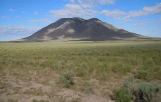 A mountain in the background on the trail of the Atomic City to Big Southern Butte.